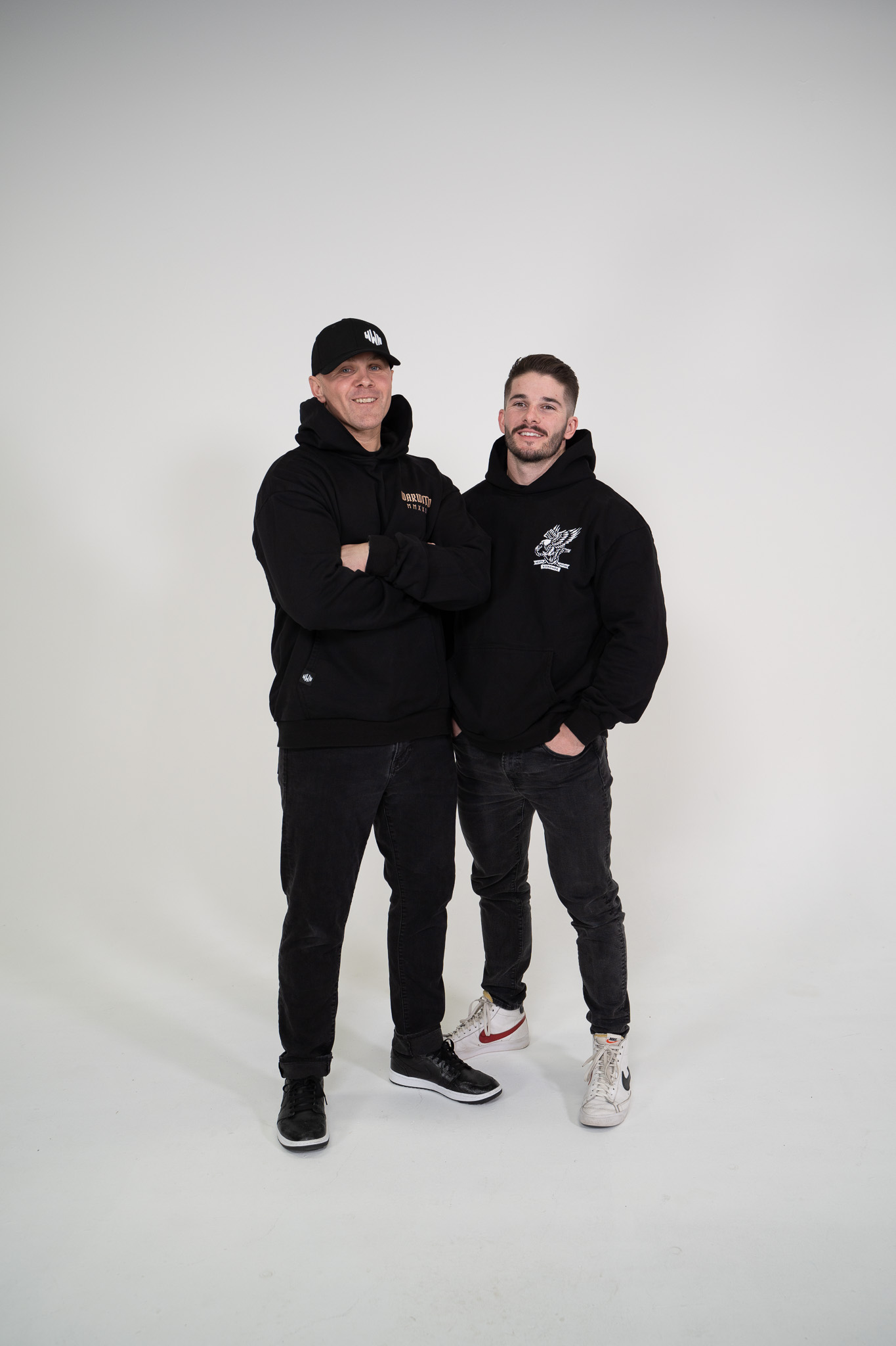 Jake and Adam standing together in their WarWithN hoodies